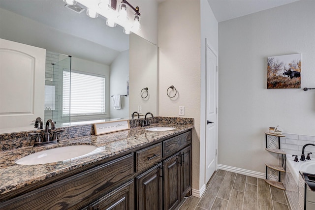 bathroom featuring vanity, vaulted ceiling, and separate shower and tub