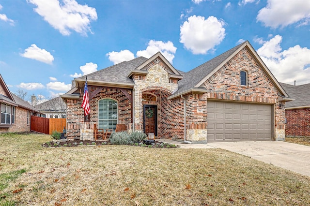 view of front of home with a garage and a front lawn