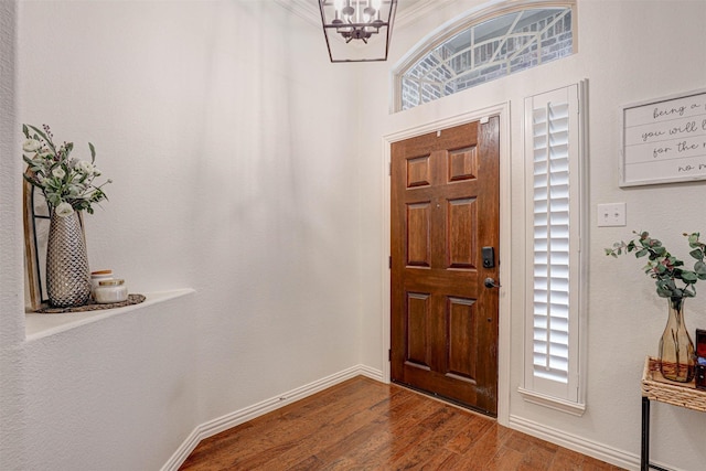 entrance foyer with dark wood-type flooring and a chandelier