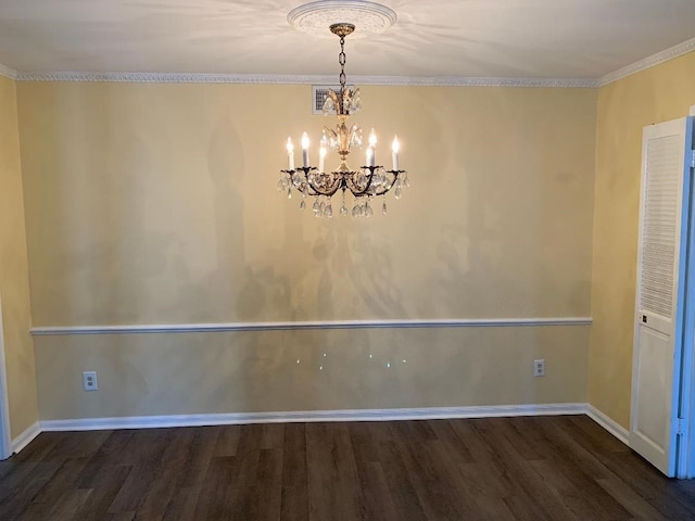 unfurnished dining area featuring crown molding, dark wood-type flooring, and an inviting chandelier