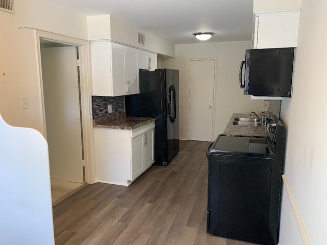 kitchen featuring range with electric cooktop, tasteful backsplash, dark wood-type flooring, sink, and white cabinets