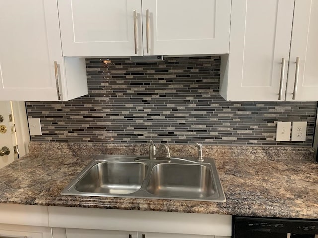 kitchen featuring tasteful backsplash, white cabinetry, and sink