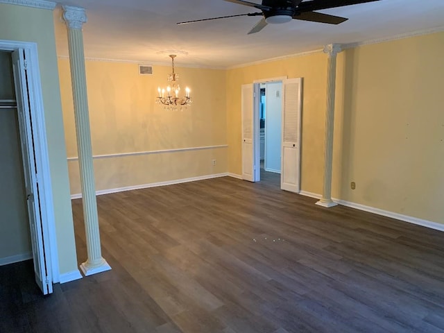 empty room with ornamental molding, dark hardwood / wood-style floors, ceiling fan with notable chandelier, and ornate columns