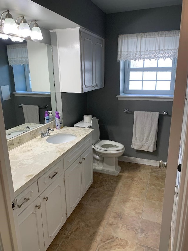 bathroom featuring vanity and toilet