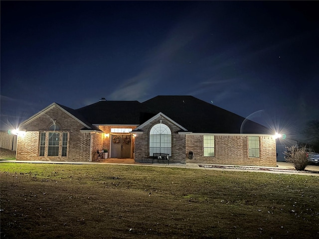 ranch-style home with a yard