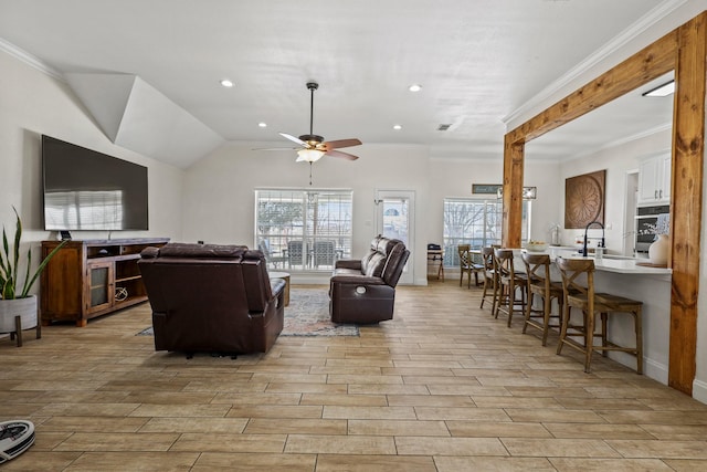 living room featuring ornamental molding, ceiling fan, lofted ceiling, and sink