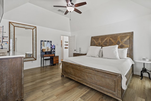 bedroom with hardwood / wood-style flooring, ceiling fan, and lofted ceiling