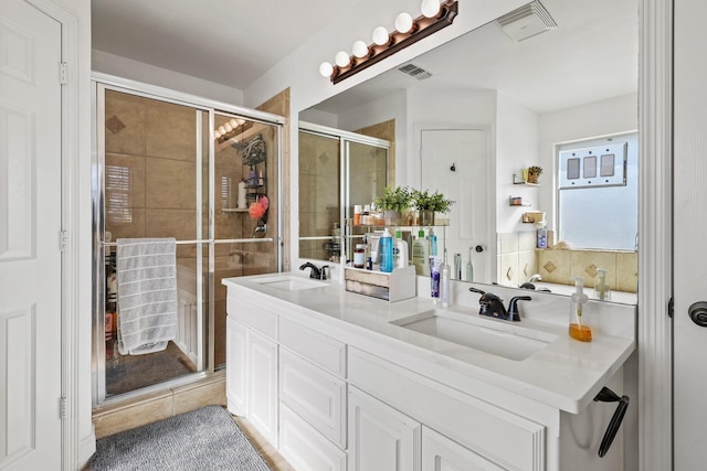 bathroom featuring vanity and an enclosed shower