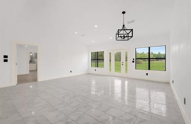 unfurnished living room featuring a high ceiling