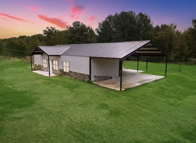 back house at dusk with a yard