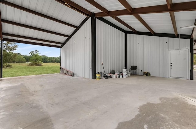 garage featuring a carport and wood walls