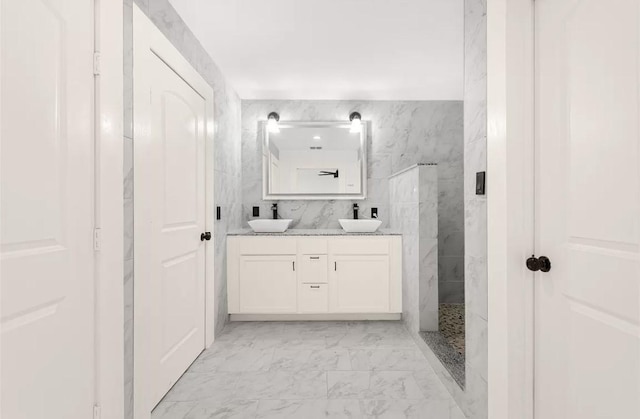 bathroom with vanity, walk in shower, and tile walls