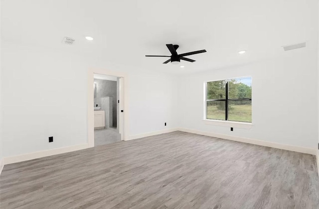 unfurnished room with ceiling fan and light hardwood / wood-style floors