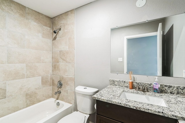 full bathroom featuring vanity, tiled shower / bath combo, and toilet