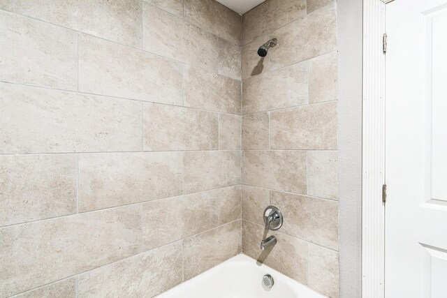 interior details with tiled shower / bath