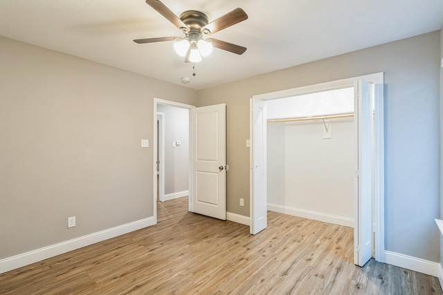 unfurnished bedroom featuring ceiling fan, a closet, and light hardwood / wood-style flooring