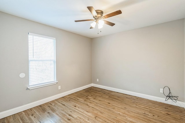 empty room with light hardwood / wood-style floors, ceiling fan, and a healthy amount of sunlight