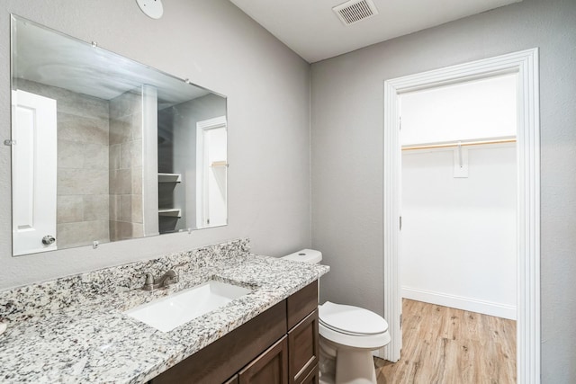 bathroom featuring hardwood / wood-style floors, vanity, and toilet