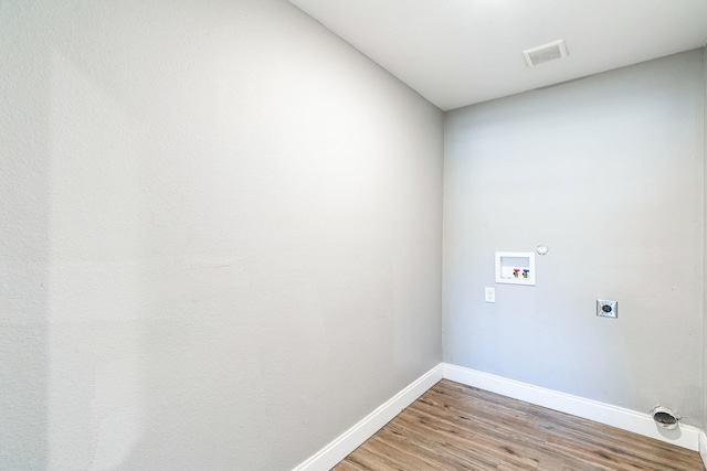 laundry room with hookup for an electric dryer, hardwood / wood-style flooring, and washer hookup