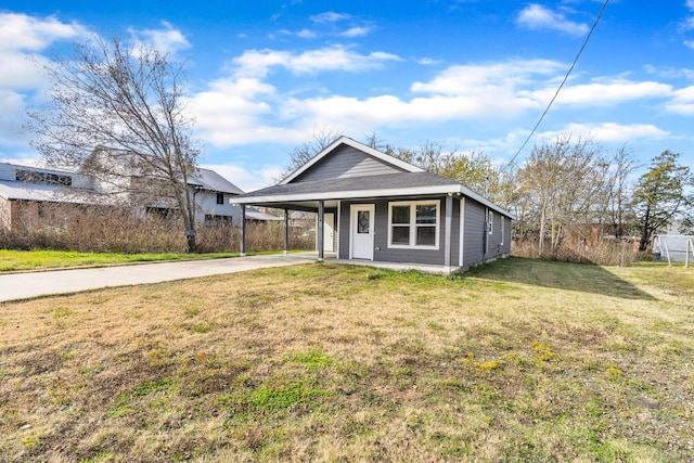 view of front of property with a carport and a front lawn