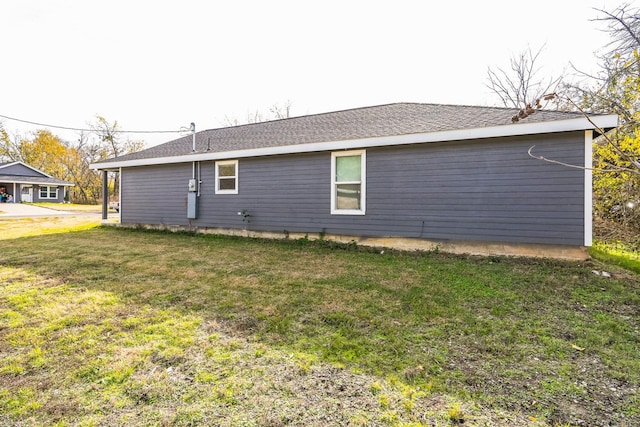 view of side of home featuring a yard