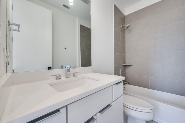 full bathroom with toilet, vanity, and tiled shower / bath