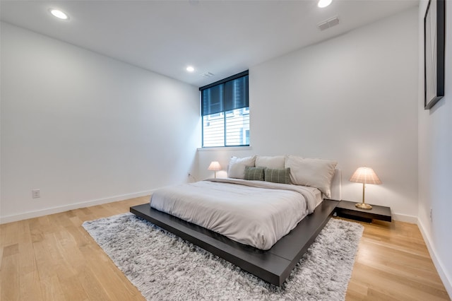 bedroom with wood-type flooring