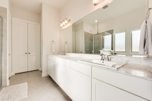 bathroom featuring tile patterned flooring, vanity, and an enclosed shower