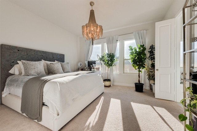 carpeted bedroom featuring lofted ceiling and a notable chandelier