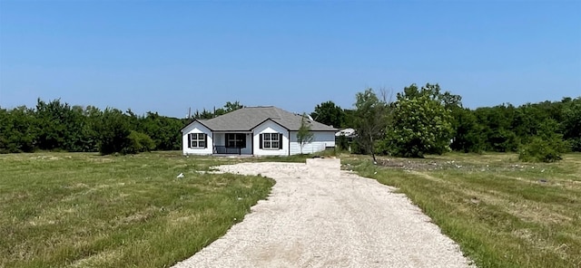 view of front of property with a rural view and a front lawn