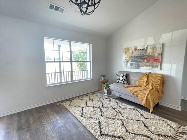 living area with dark wood-type flooring and lofted ceiling