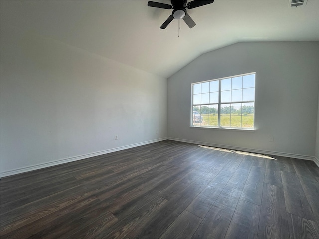 spare room with vaulted ceiling, dark hardwood / wood-style floors, and ceiling fan