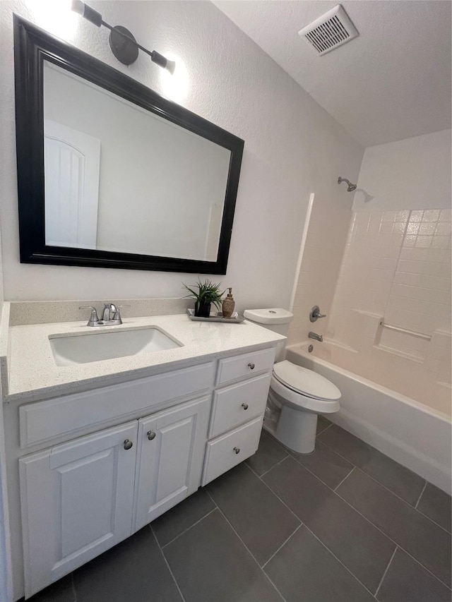 full bathroom with vanity, tile patterned floors, washtub / shower combination, and toilet