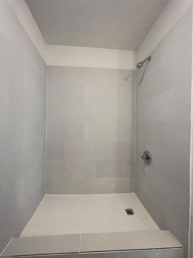 bathroom with a tile shower