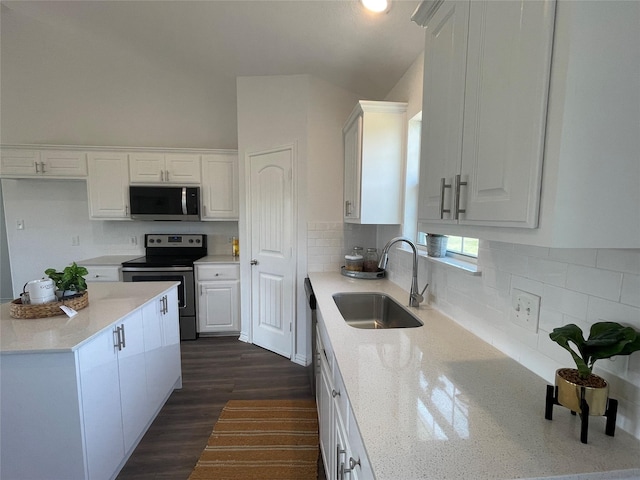 kitchen featuring light stone counters, appliances with stainless steel finishes, sink, and white cabinets