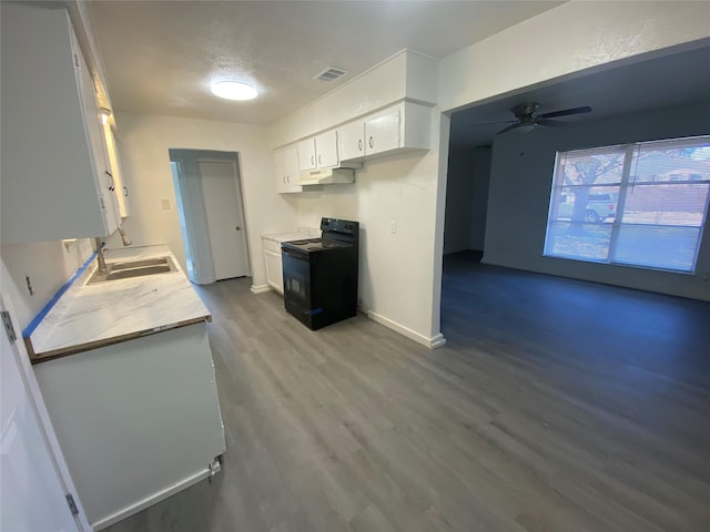 kitchen featuring ceiling fan, white cabinetry, black range with electric stovetop, and sink