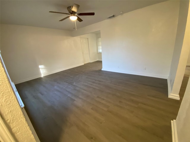 unfurnished room with dark hardwood / wood-style floors and ceiling fan