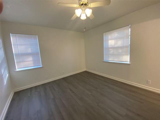 empty room featuring ceiling fan and dark wood-type flooring