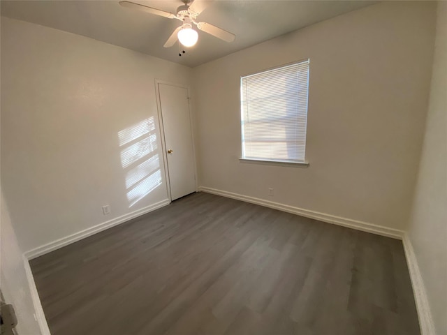 spare room featuring ceiling fan and dark hardwood / wood-style floors