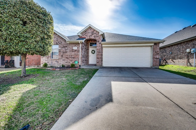 ranch-style house featuring a garage and a front lawn