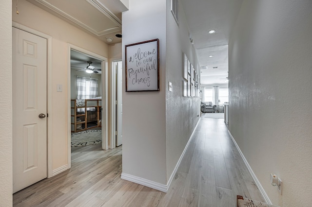 corridor with light hardwood / wood-style flooring