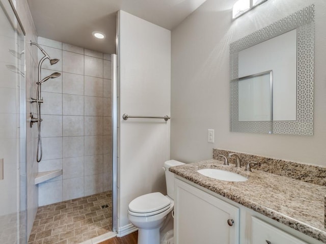 bathroom with vanity, toilet, and walk in shower