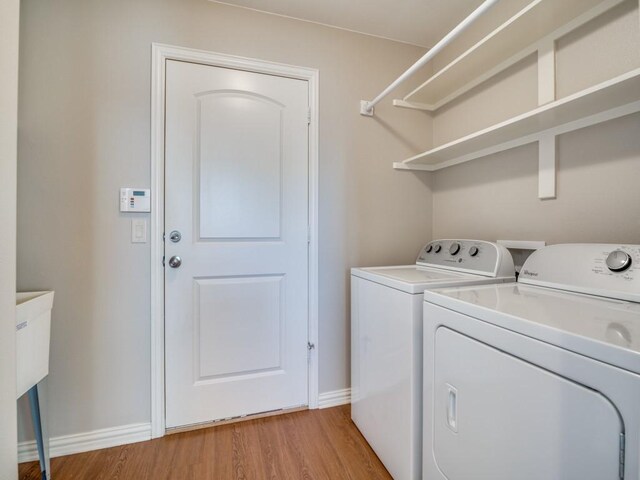 laundry area featuring washer and dryer and light wood-type flooring