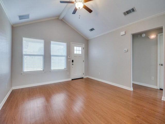 interior space featuring ceiling fan, crown molding, lofted ceiling with beams, and light wood-type flooring