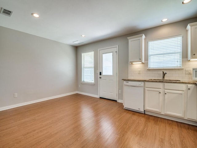 kitchen featuring white cabinets, light wood-type flooring, white dishwasher, and sink