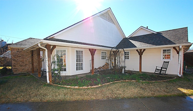 view of front of property with a front yard and covered porch