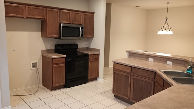 kitchen featuring light tile patterned flooring, sink, black range with electric cooktop, and hanging light fixtures