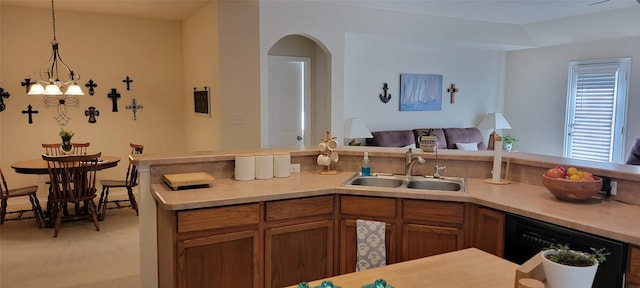 kitchen featuring dishwasher, sink, pendant lighting, and light colored carpet