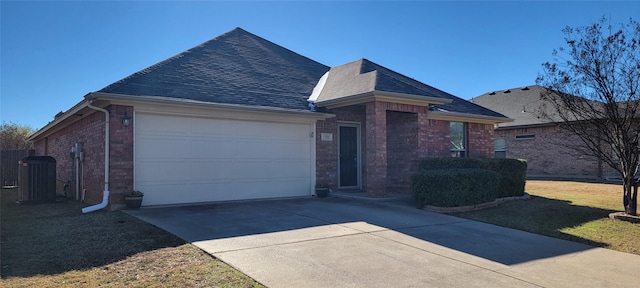 view of front facade with a garage and central AC unit