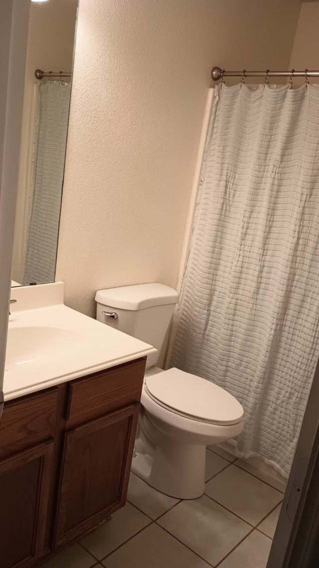 bathroom featuring tile patterned floors, toilet, and vanity